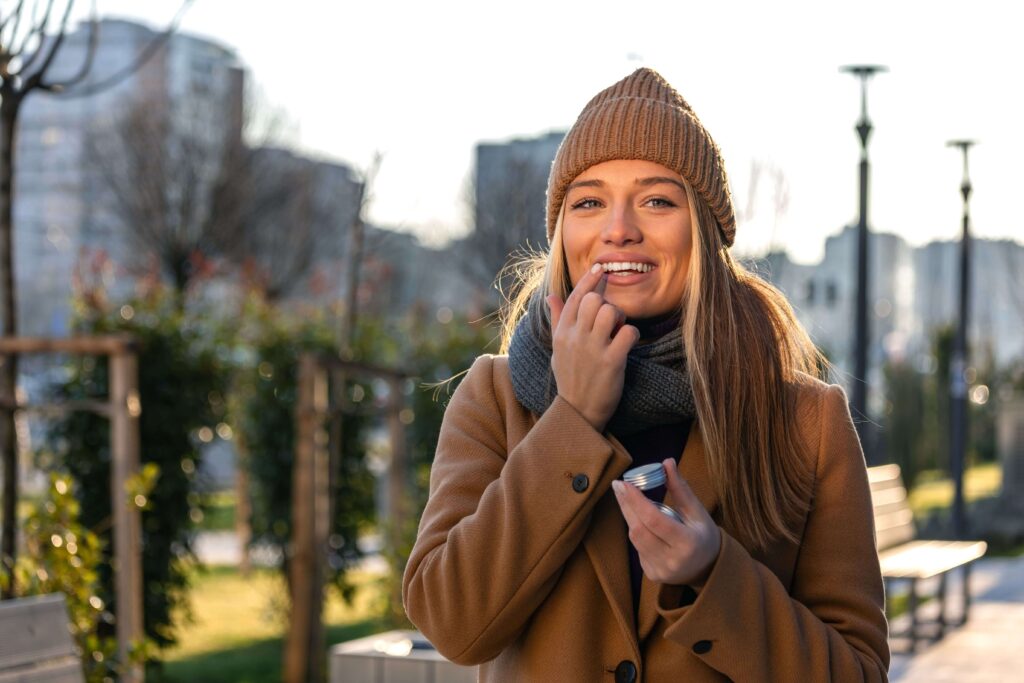 happy woman brown hat and coat outside winter facial in fairfax va
